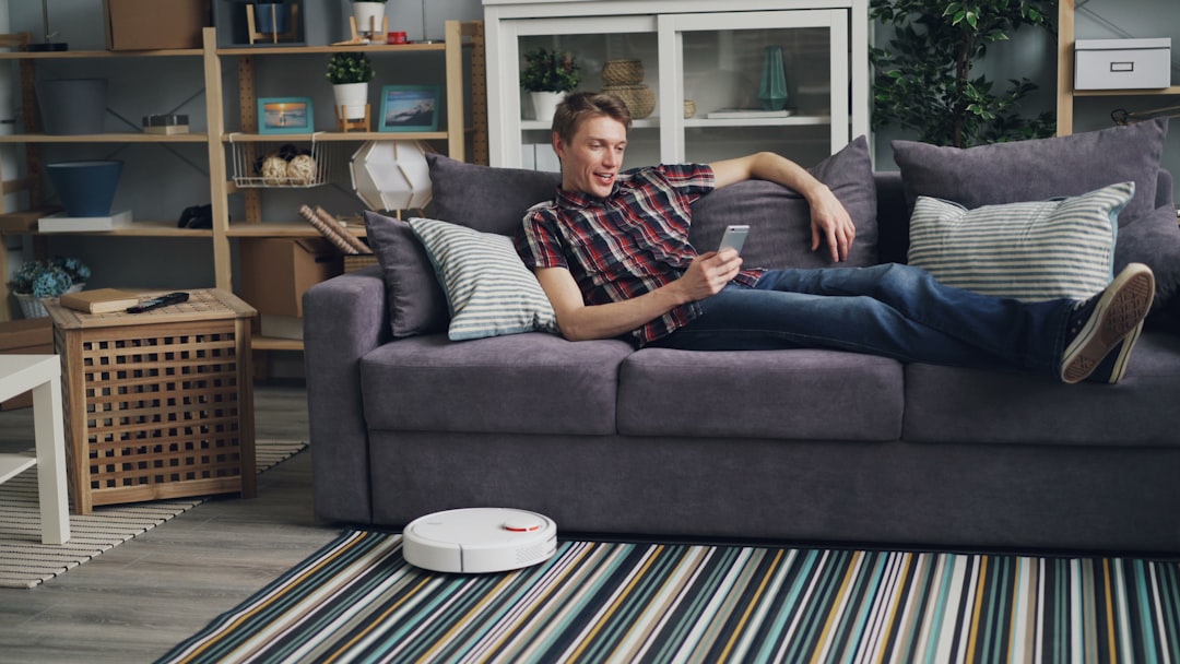 a man laying on a couch with a remote control