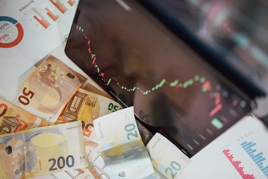 Close-up of euro banknotes with a digital stock market chart displaying a downward trend, symbolizing financial volatility.