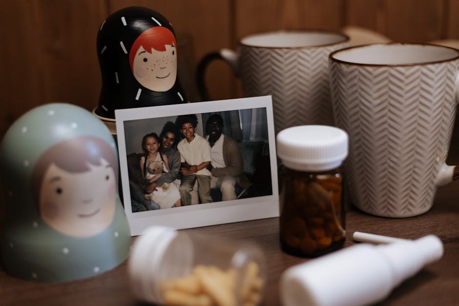 Warm and inviting indoor scene with a family photo, nested dolls, mugs, and medication bottles on a table.
