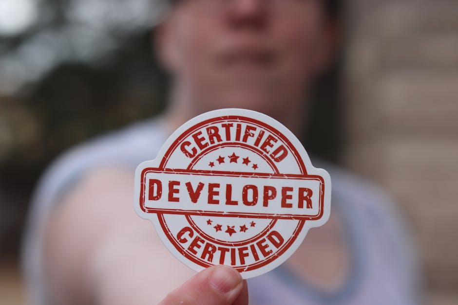 Close-up of a certified developer badge being held outdoors.