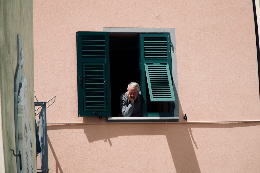 middle aged man looking thoughtful at window