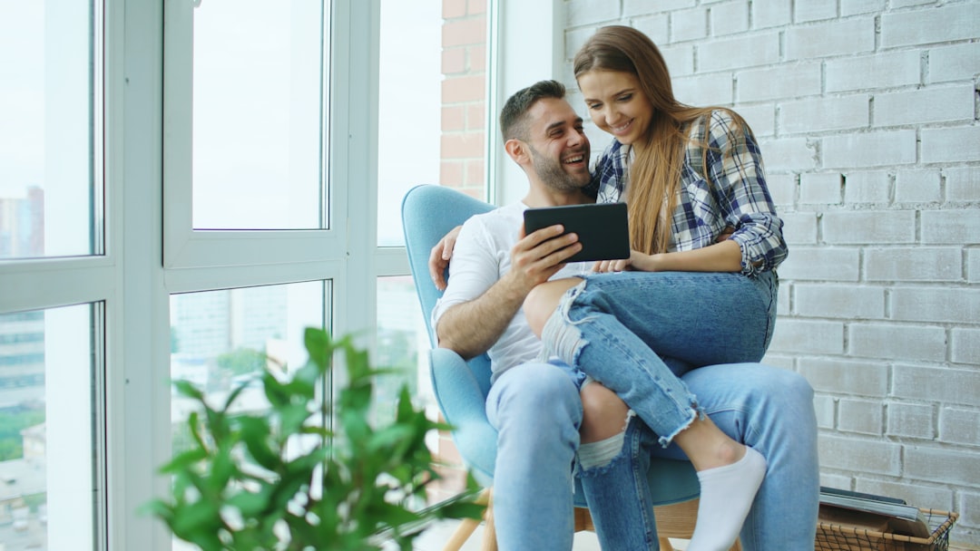 Couple sitting together looking at tablet