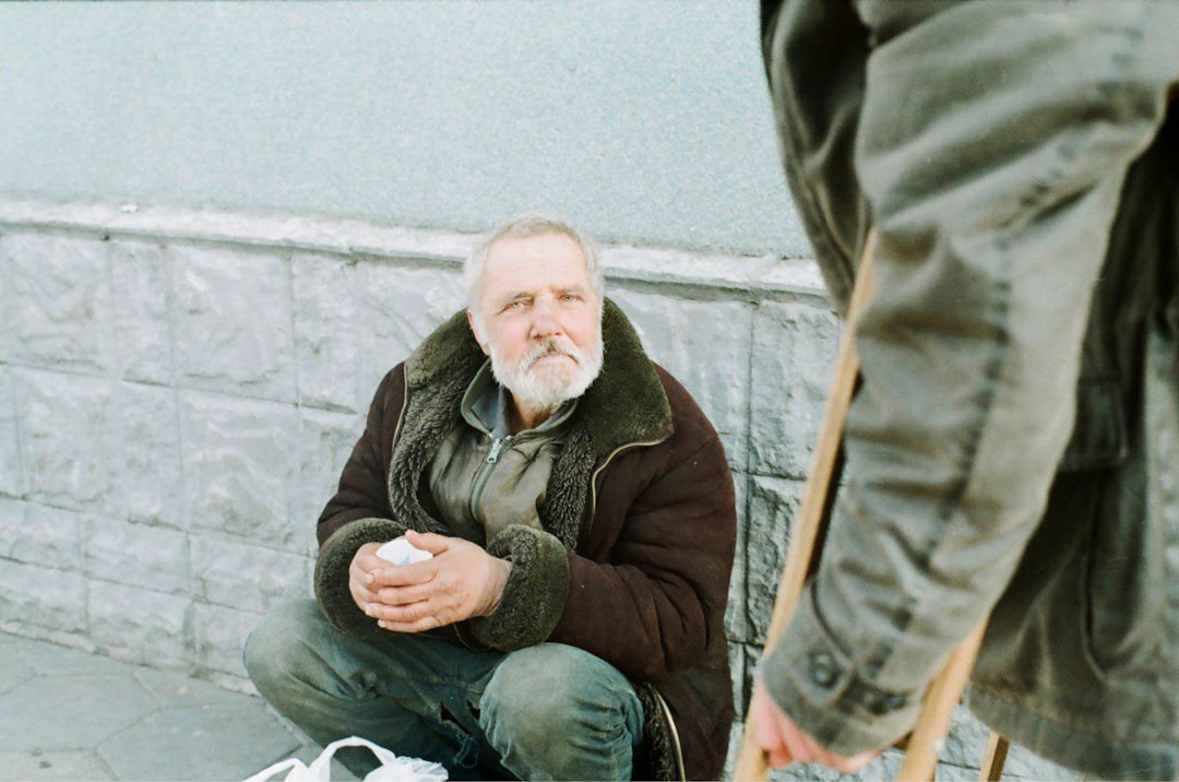 man in brown coat sitting on chair